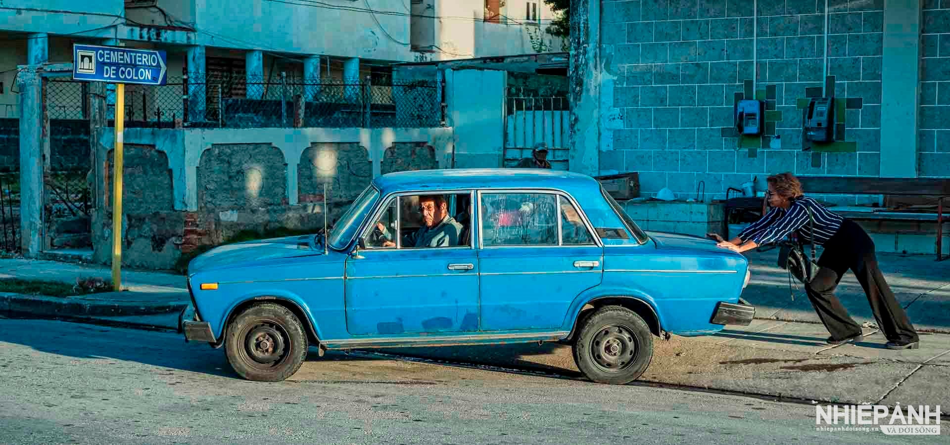 W_104-vn25-worldinfocus-acc-cuban-woman-starting-car-nguyen-ngoc-van-vietnam.jpg